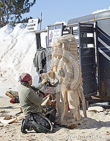 Man Carving Indian Chief details with Chainsaw