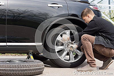 Man changing his spare wheel
