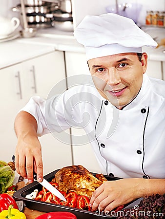 Man in chef hat cooking chicken