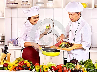 Man in chef hat cooking chicken