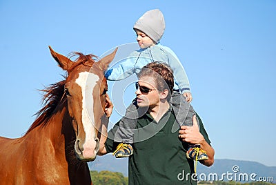 Man, child and horse