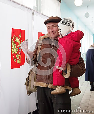 Man with child votes in Russian election