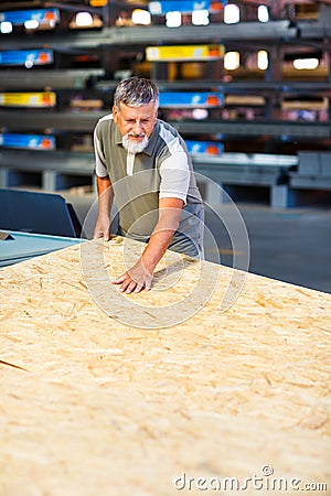 Man choosing and buying construction wood in a DIY store