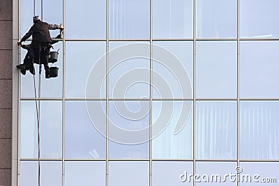 Man cleaning windows on a corporate bouilding