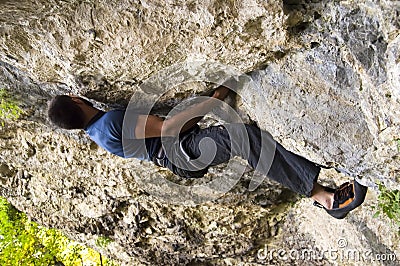 Man climbing a boulder