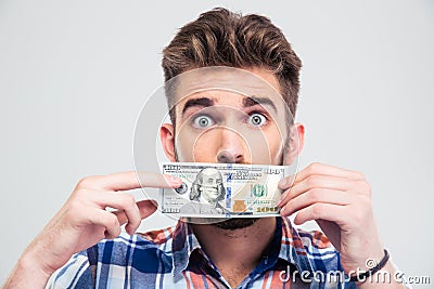 Man covering his mouth with bill of USA dollar - man-covering-his-mouth-bill-usa-dollar-portrait-young-isolated-white-background-57491177