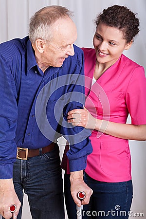 Man on crutches and his nurse