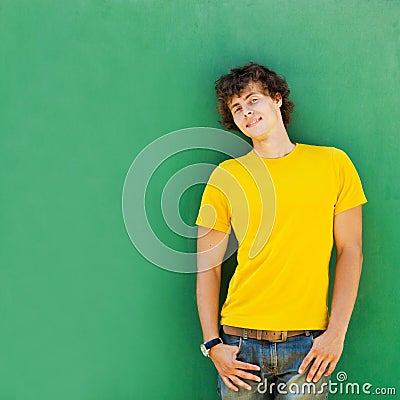 Man with curly hair in a yellow T-shirt