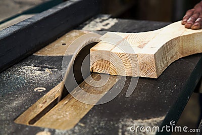 Man cutting wood by circular saw blade