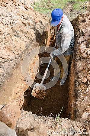 A man digs grave