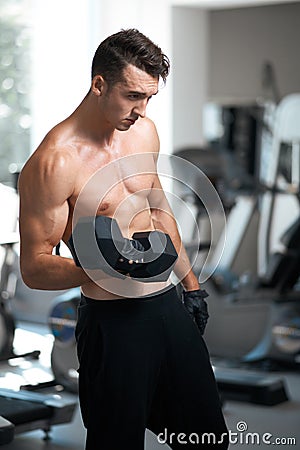 Man doing exercises dumbbell bicep muscles