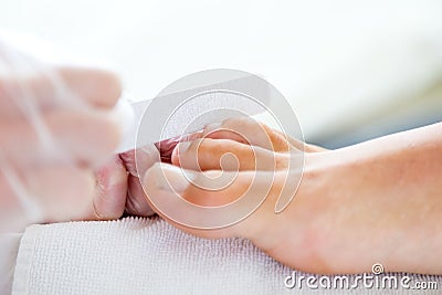 Man doing pedicure in salon. Beauty concept.