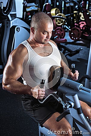 Man doing workout with pull-down machine