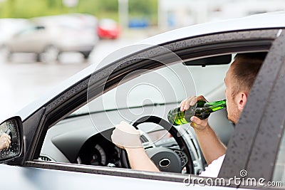 Man drinking alcohol while driving the car