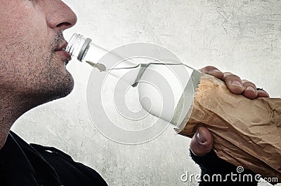 Man drinking vodka from bottle