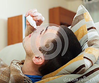 Man dripping nasal drops