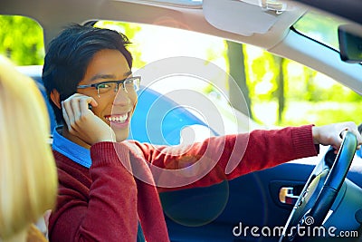 Man driving car and speaking on mobile phone