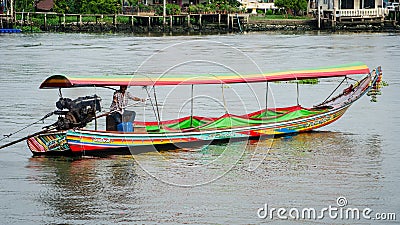 Man driving a longtail boat