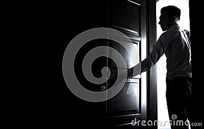 Man entering a dark room