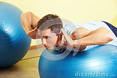 Man exercising on gym ball