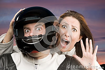 Man and fearful woman on a motorcycle