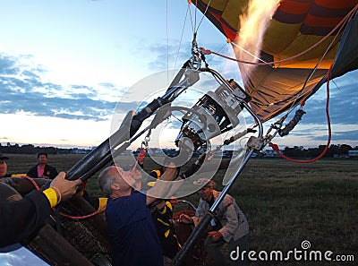 Man filling hot air into balloon