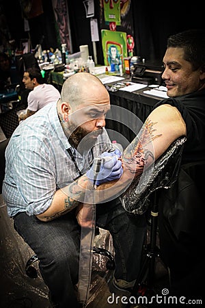 Man getting tattoo on arm