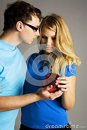 Man and girl holding red ball