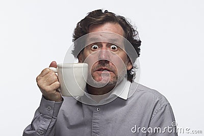 Man had too much coffee (holding mug), horizontal