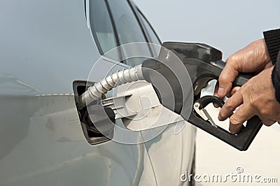 Man hand fill up fuel at gas station