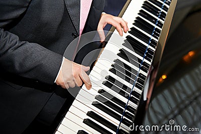 Man hands playing piano