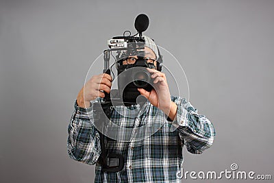 Man with HD SLR camera and audio equipment