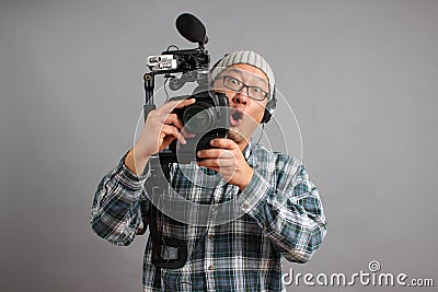 Man with HD SLR camera and audio equipment