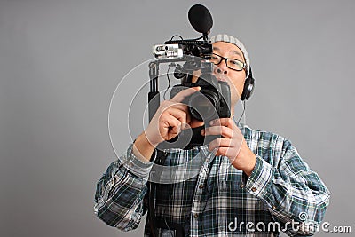 Man with HD SLR camera and audio equipment