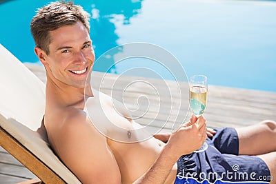 Man holding champagne flute by the swimming pool