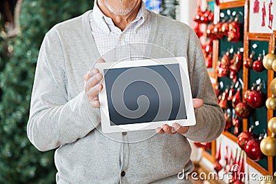 Man Holding Digital Tablet At Christmas Store
