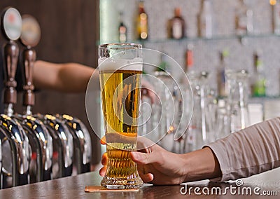 Man holding a full pint glass of beer