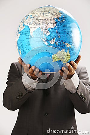 Man holding globe over face