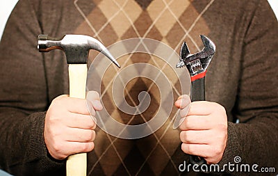 Man holding hammer and wrench