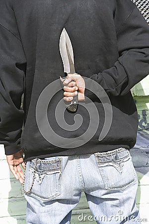 Man Holding Knife Behind Back