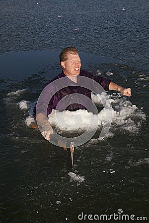 Man in ice hole hold axe freezing