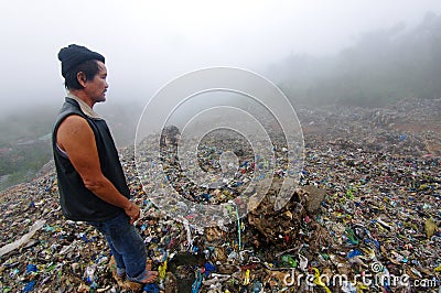 Man Inspecting an Mountain of Trash