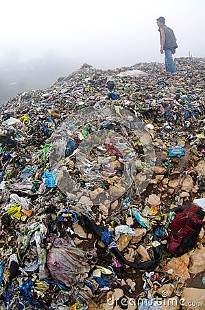 Man Inspecting an Mountain of Trash