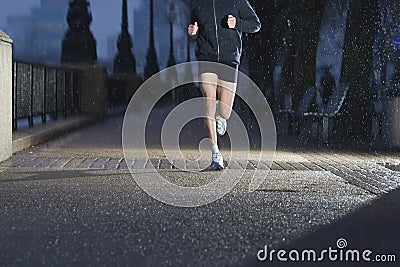 Man Jogging On City Pavement At Dawn