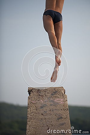 Man jumping from diving platform