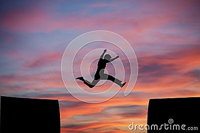 Man jumping a gap in sunset sky