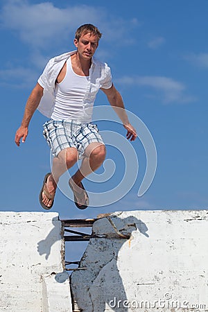 Man Jumping Over Wall
