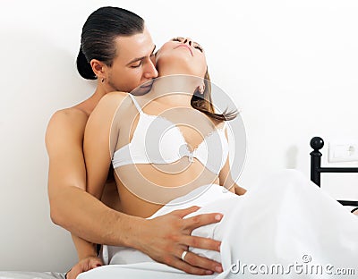 Man kissing girl in neck