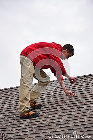 Man on Ladder on a roof