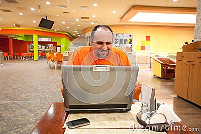 Man with laptop in restaurant